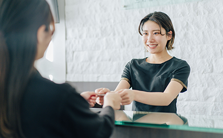 自由が丘の歯医者三好歯科自由が丘の受付で笑顔で対応する歯科助手の画像